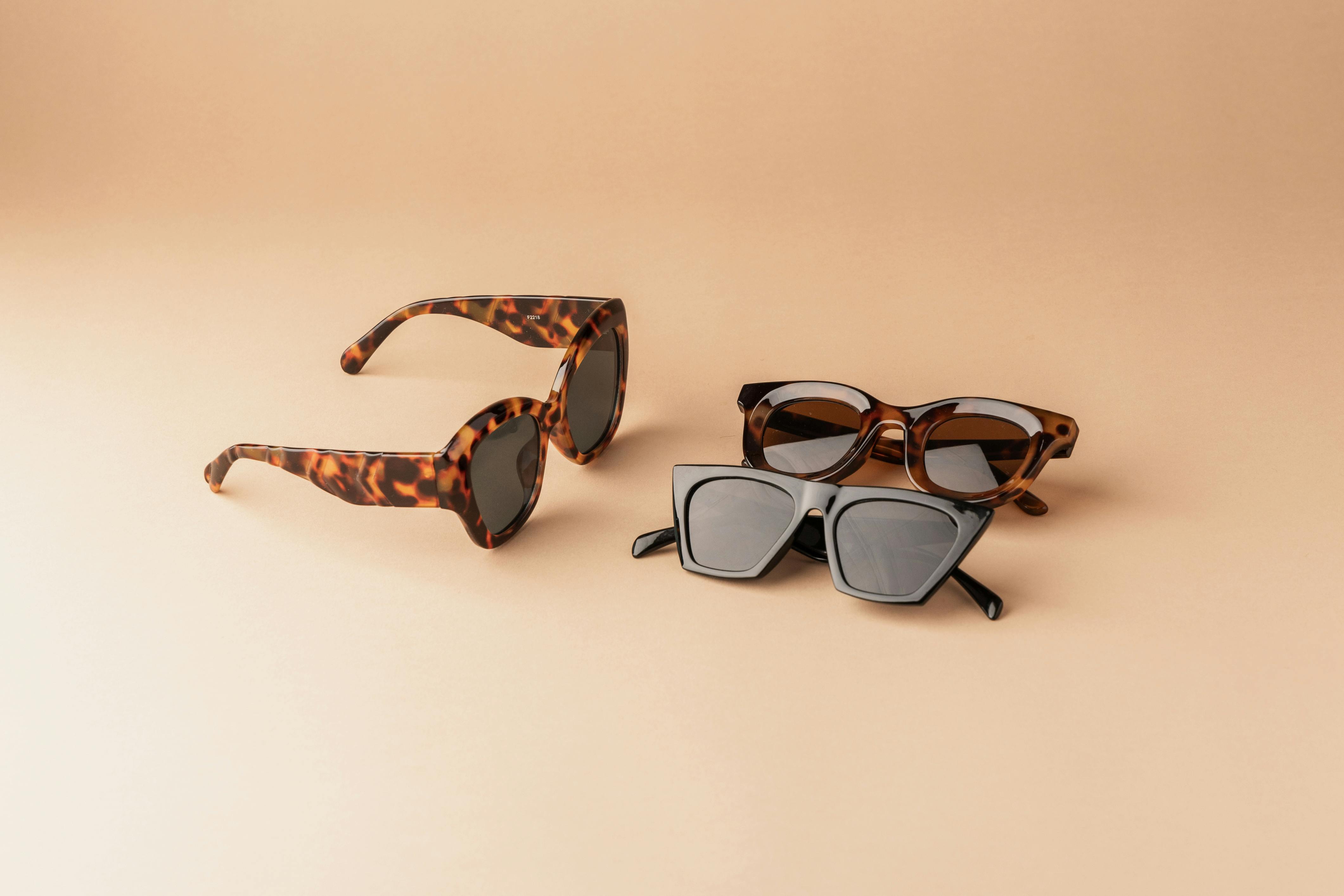 Three pairs of sunglasses arranged neatly on a clean surface