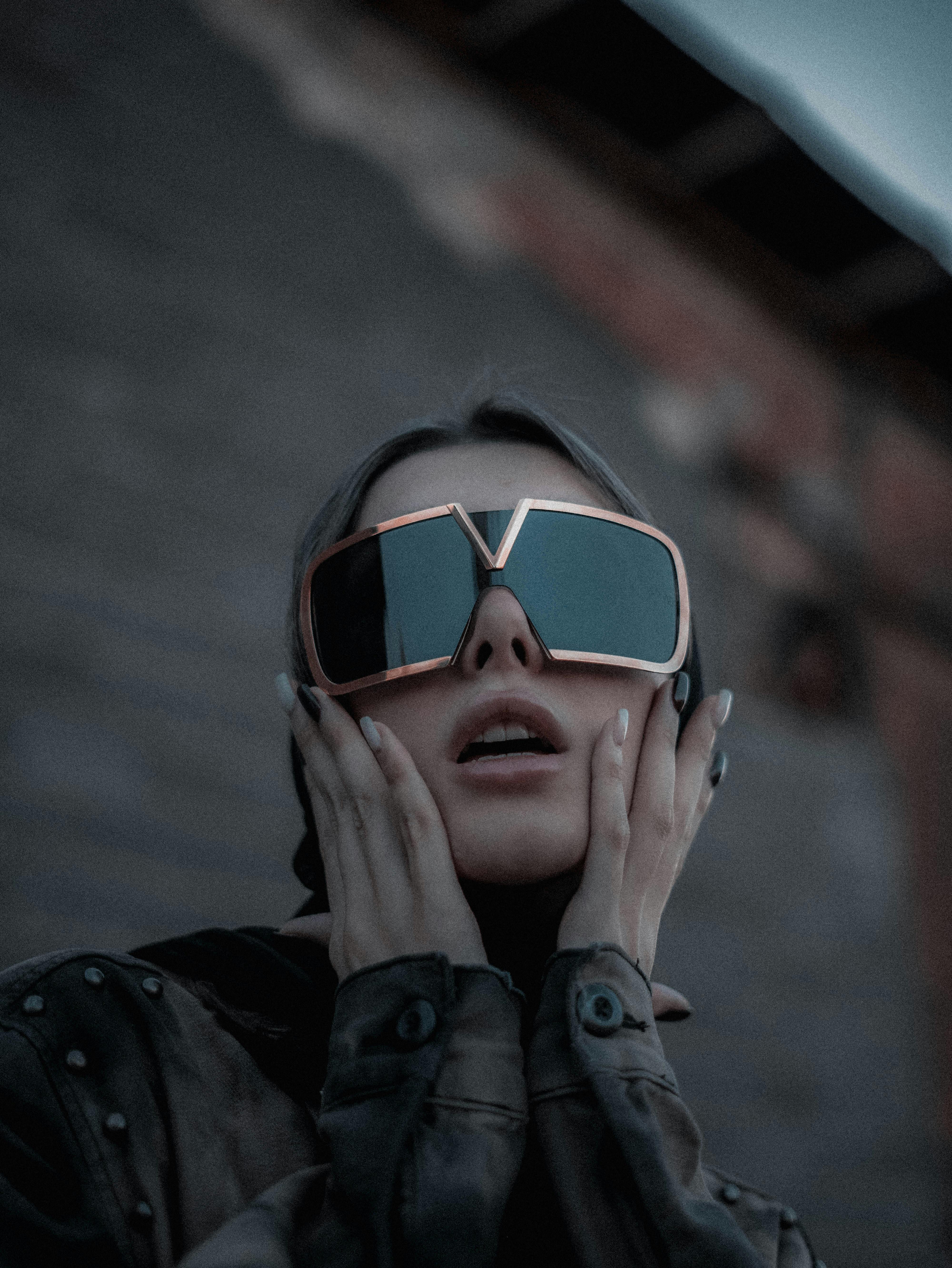 Woman wearing oversized sunglasses in an urban setting