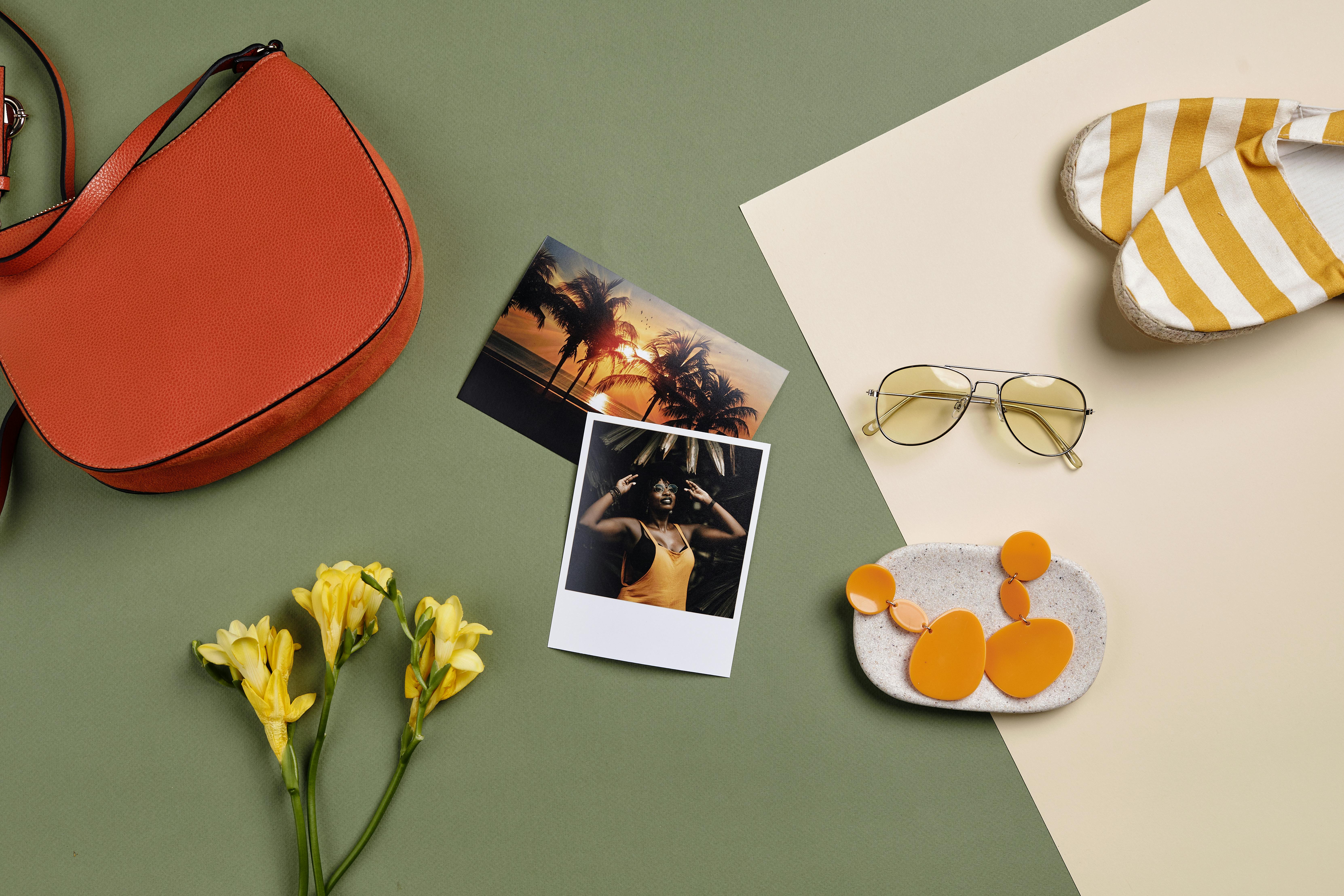 Flat lay of several sunglasses styles on a light background